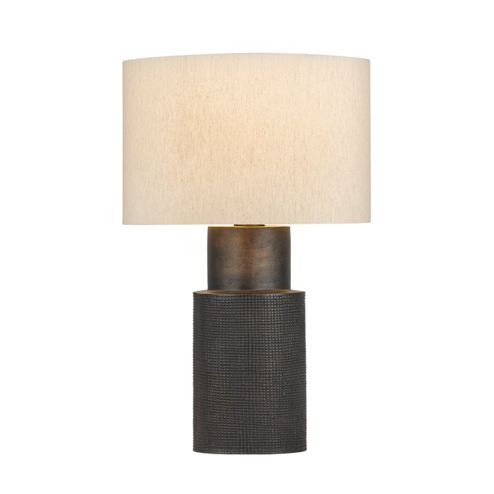 Table lamp with textured black base and beige lampshade on a white background