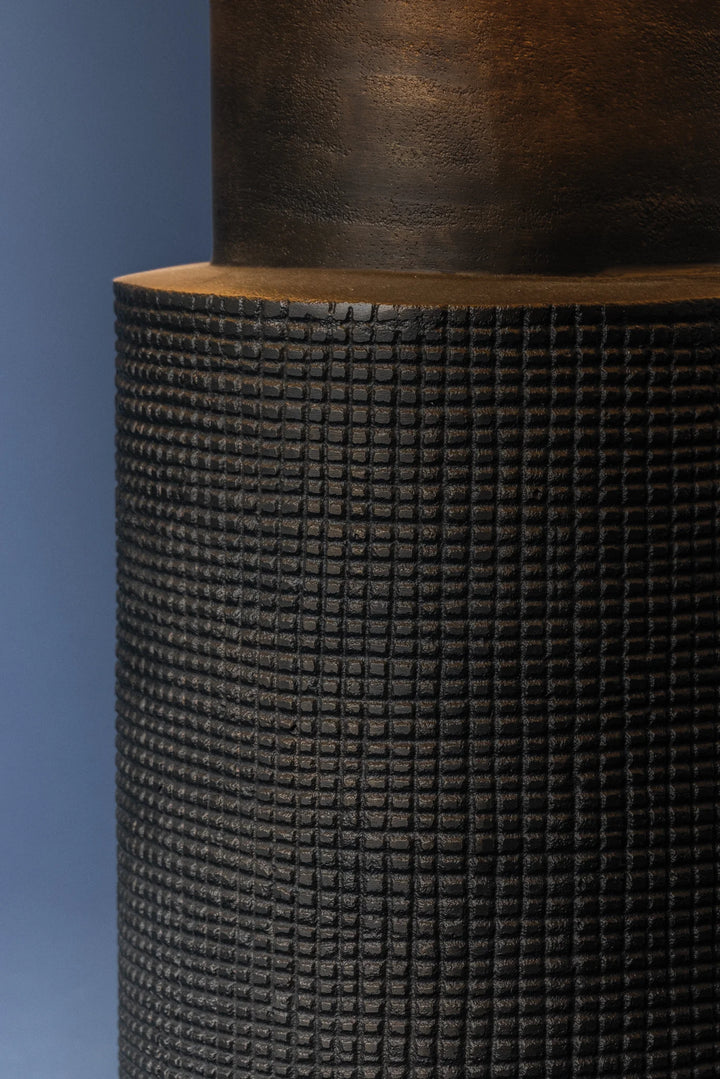 Close-up of a textured cylindrical object against a blue background