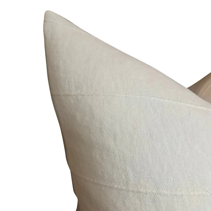 Close-up of a textured beige pillow on a white background