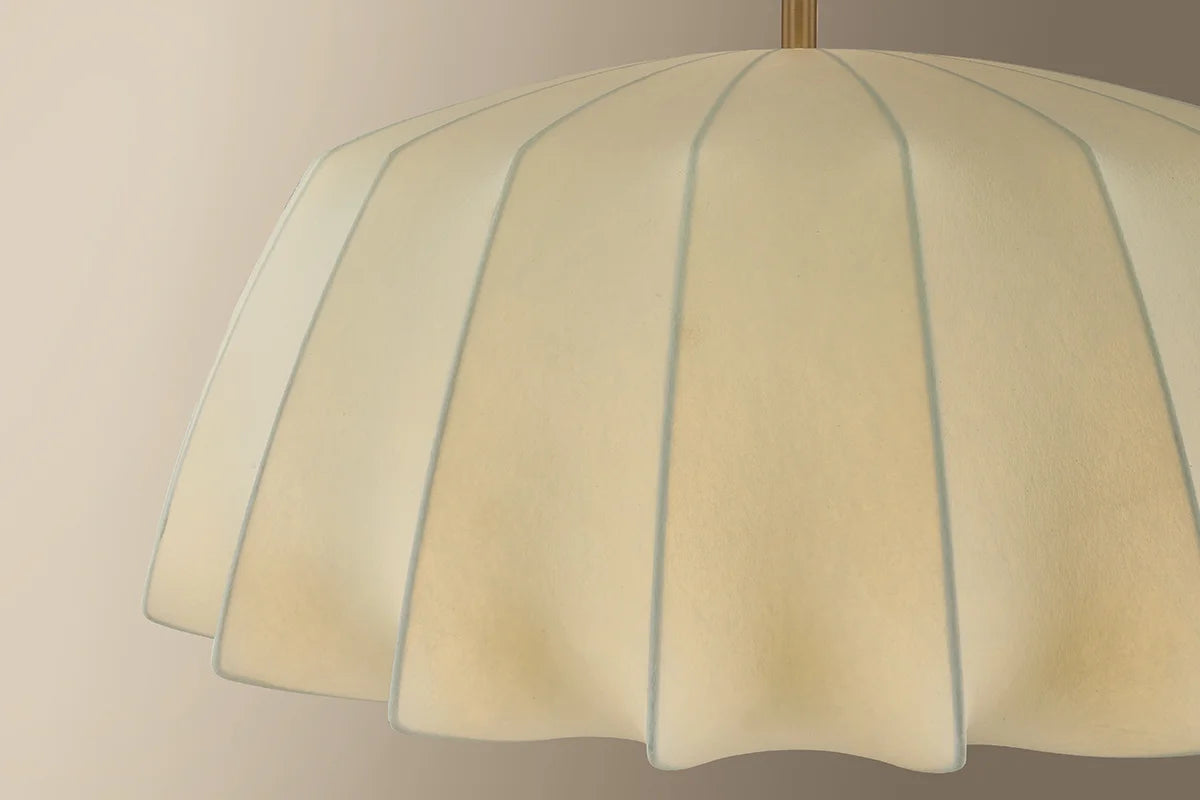 Close-up of a lampshade with a beige color and blue stripes on a plain background