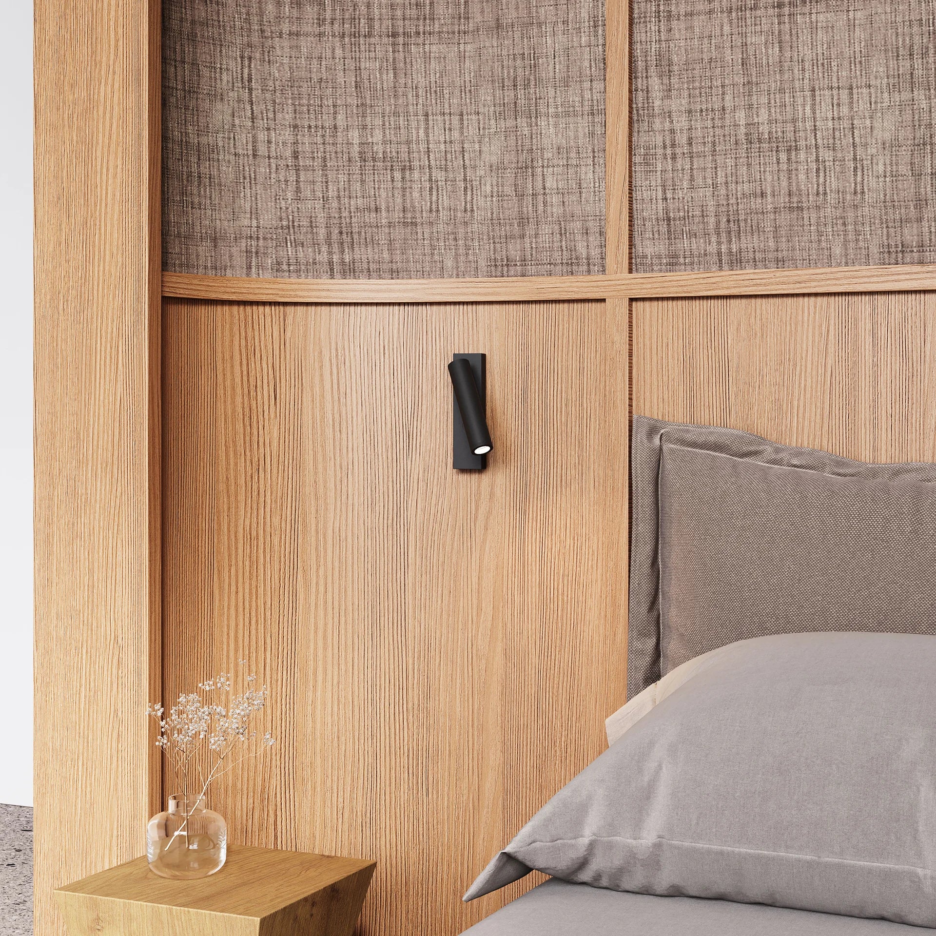 Bedroom with wooden headboard, gray bedding, and a small shelf with a vase.