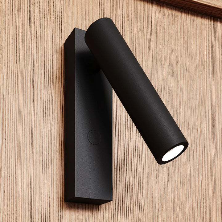 Black wall-mounted light fixture on a wooden surface