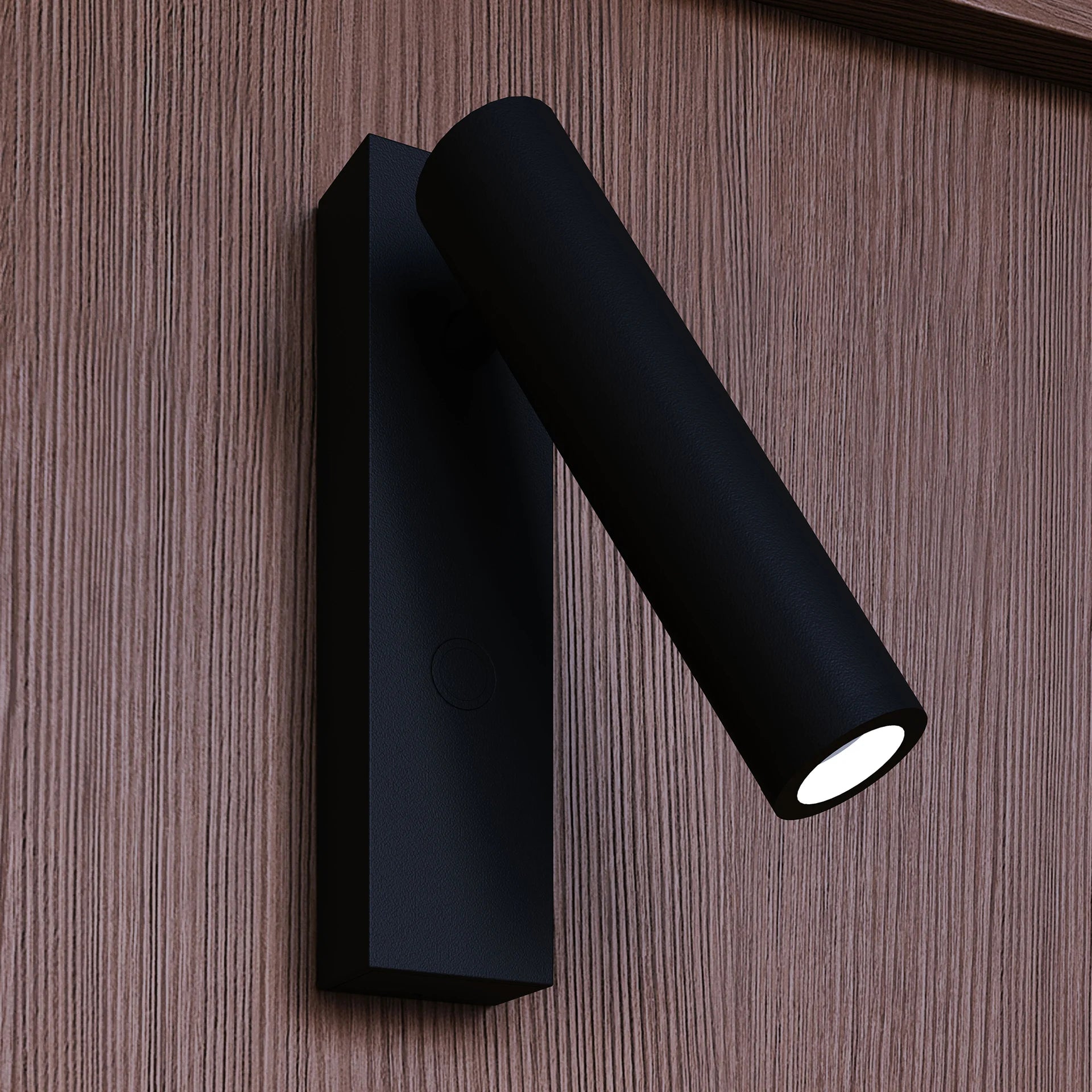 Black cylindrical wall light fixture on a wooden surface