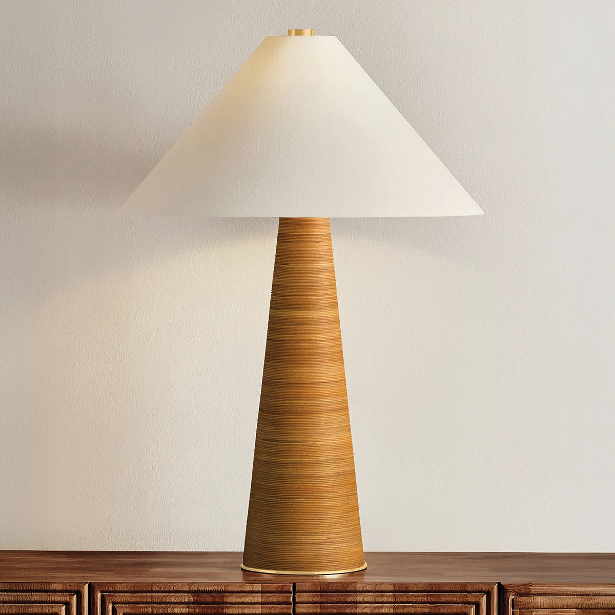 Table lamp with a textured brown base and white shade on a wooden surface.