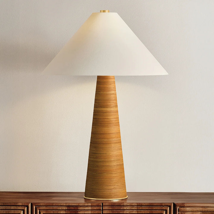 Table lamp with a textured brown base and white shade on a wooden surface.