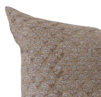 Floral-patterned pillow on a neutral background