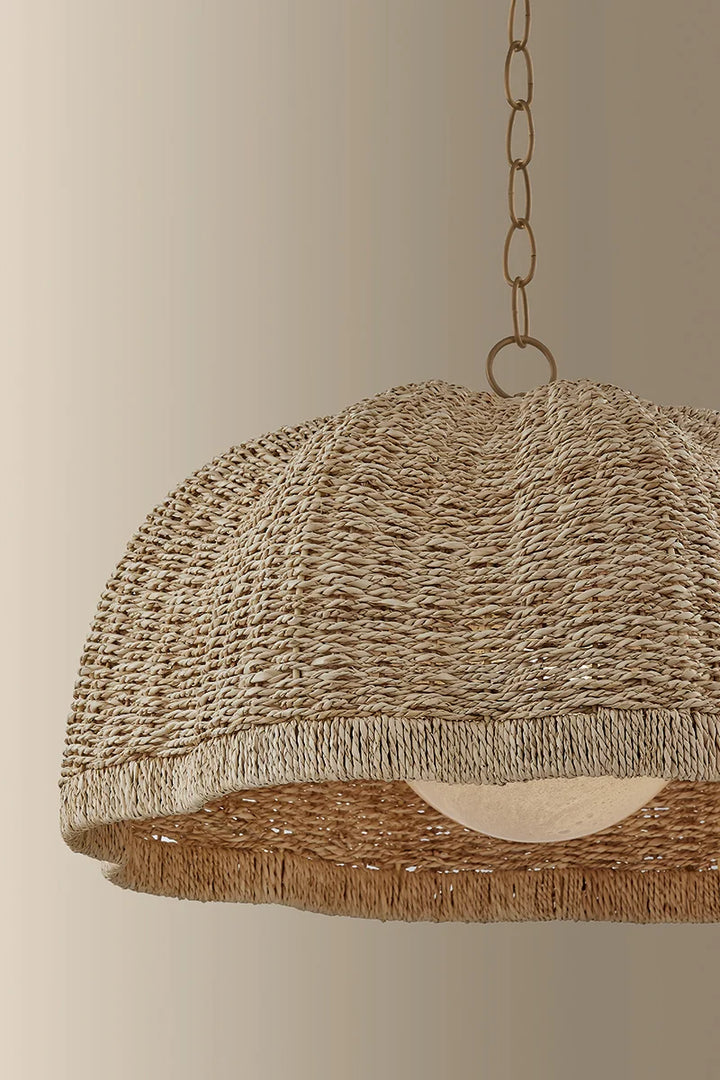 Close-up of a woven dome pendant light with natural fiber shade and hanging chain