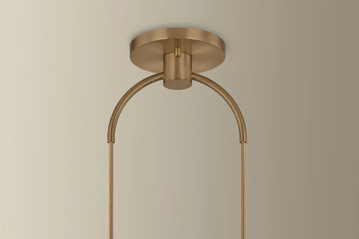 Brass ceiling light fixture on a beige background