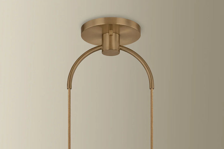 Brass ceiling light fixture on a beige background