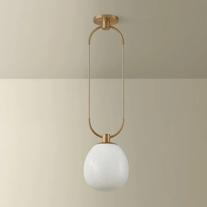 Ceiling light fixture with gold frame and white glass shade on a beige background