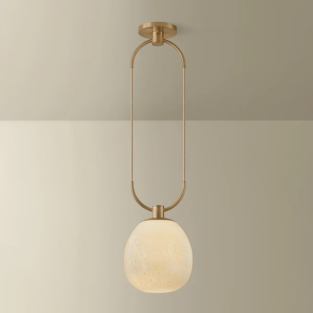 Ceiling light fixture with a round glass shade on a neutral background