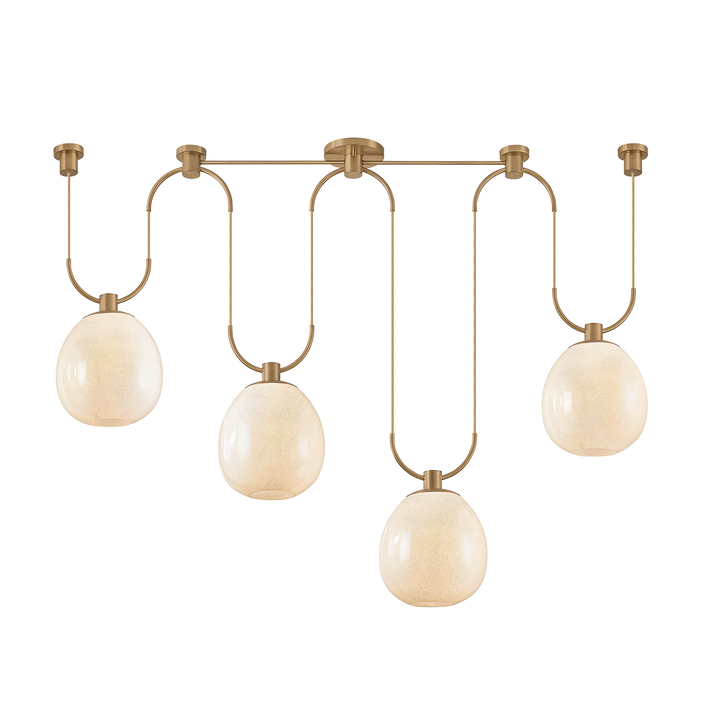 Modern chandelier with four round glass shades and brass fixtures on a white background