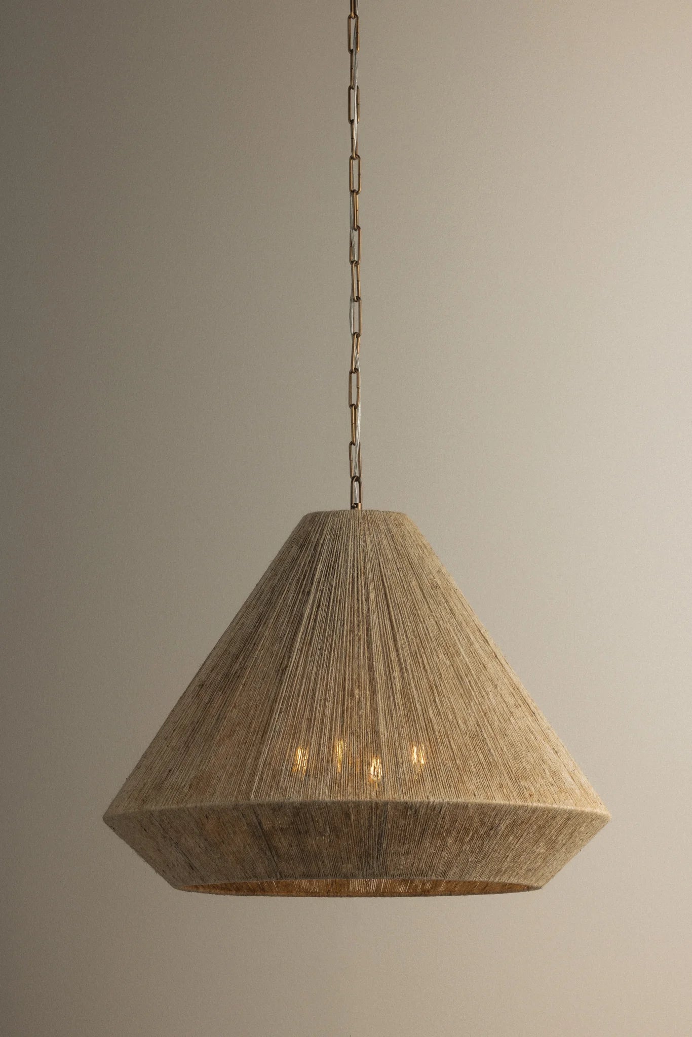 Wooden pendant light hanging against a plain background