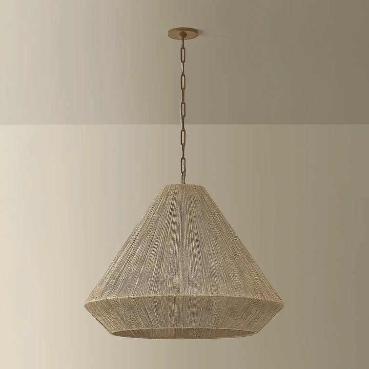 Textured pendant light hanging against a plain wall
