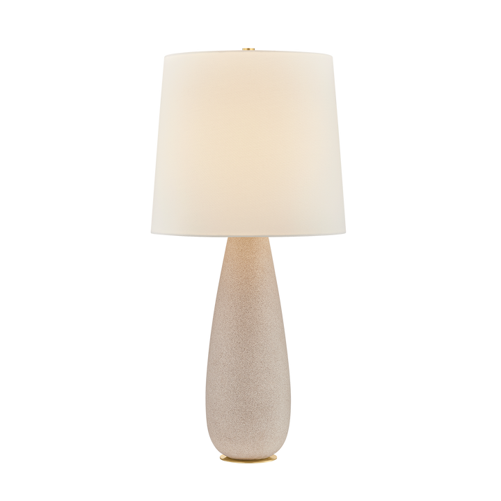 Table lamp with a beige ceramic base and white shade on a white background