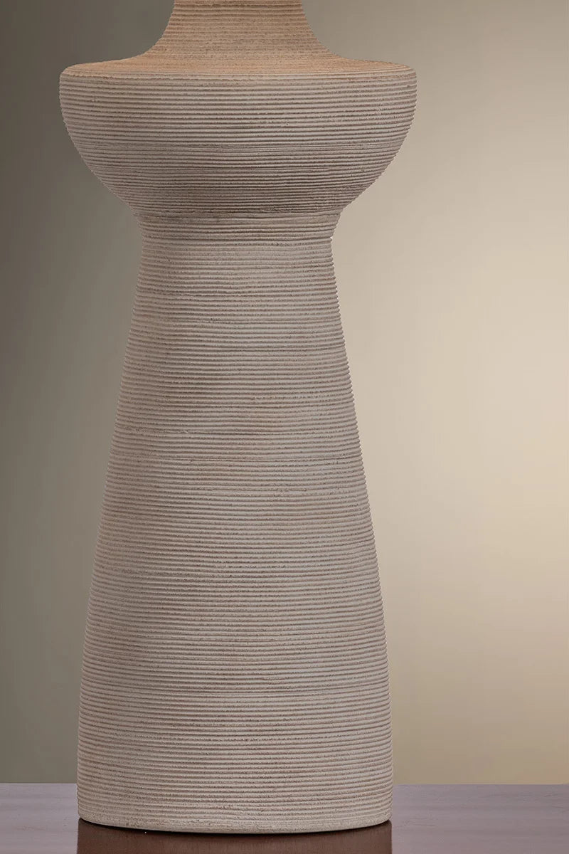 Textured dress form against a gradient background