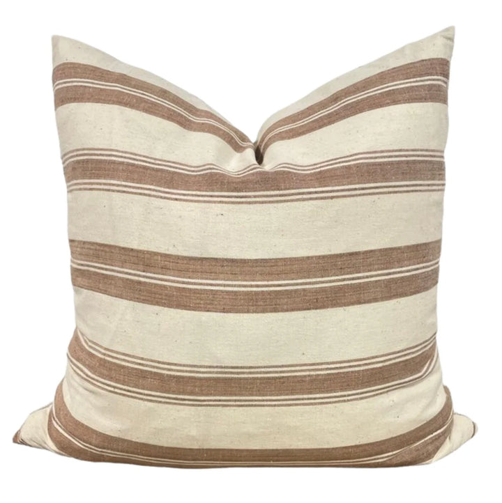 Striped pillow with brown and beige stripes on a white background