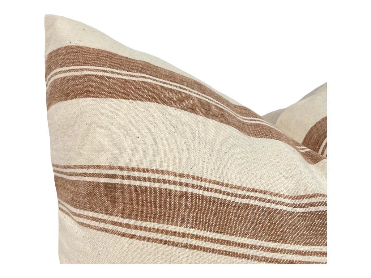 Striped pillow with brown and beige pattern on a white background