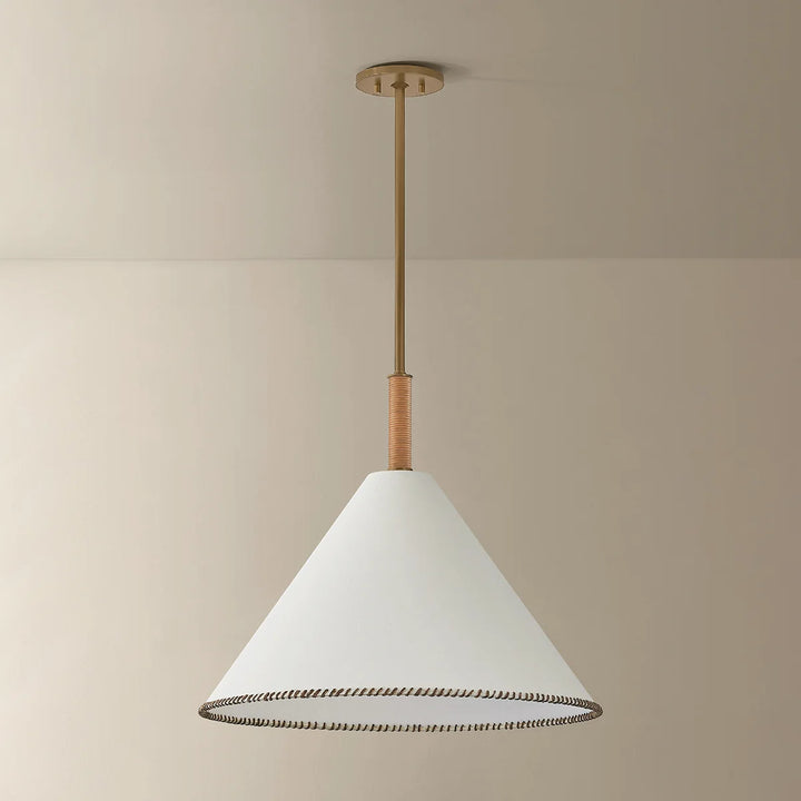 Conical pendant light with white shade and gold fixture on a beige background
